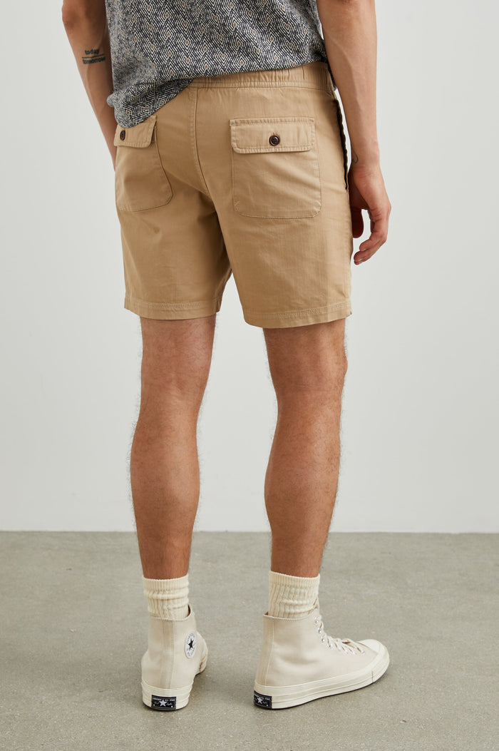 Cruz Shorts with a Drawstring Waist, Two Front Pockets, Two Back Button Flap Pockets in Khaki Colorway - Back View Featured on Model