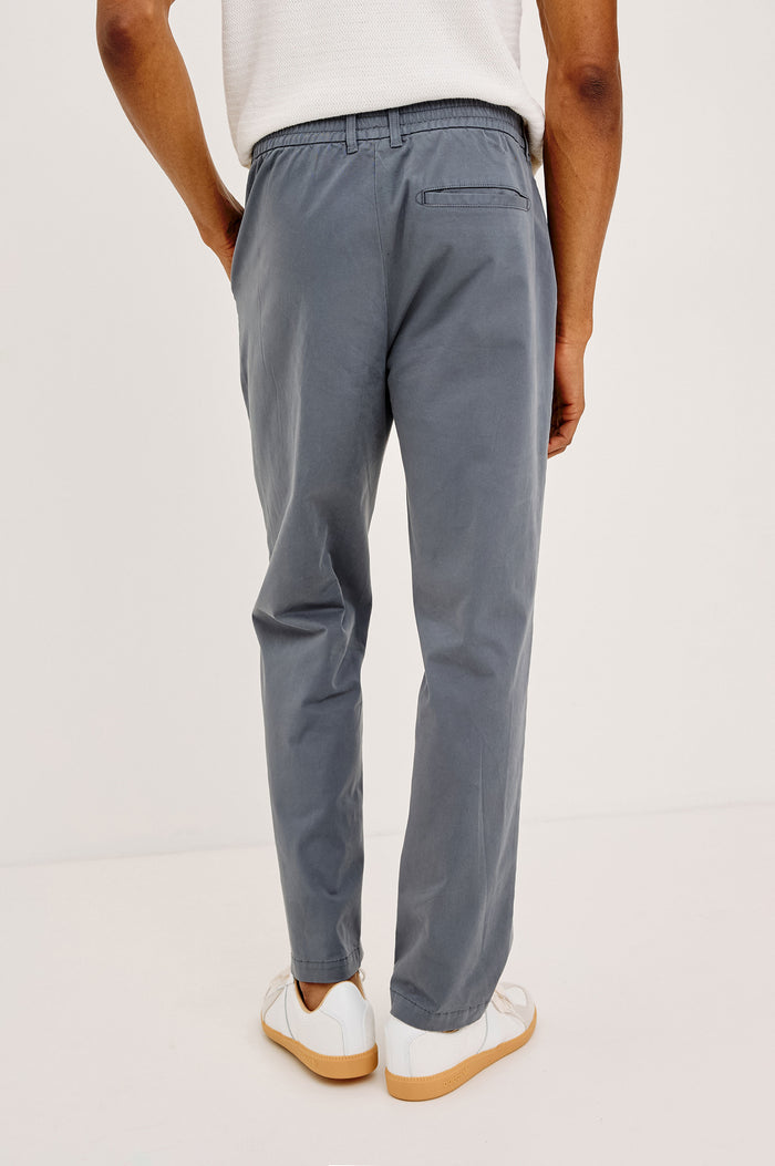 Irving Slim Straight Pant With Side Slant Pockets and Back Welt Pockets in Ensign Blue Colorway - Lower Body Back View Featured on Model