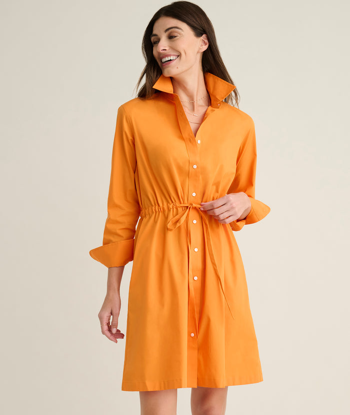 Model is wearing UNTUCKit Taylor dress in orange.