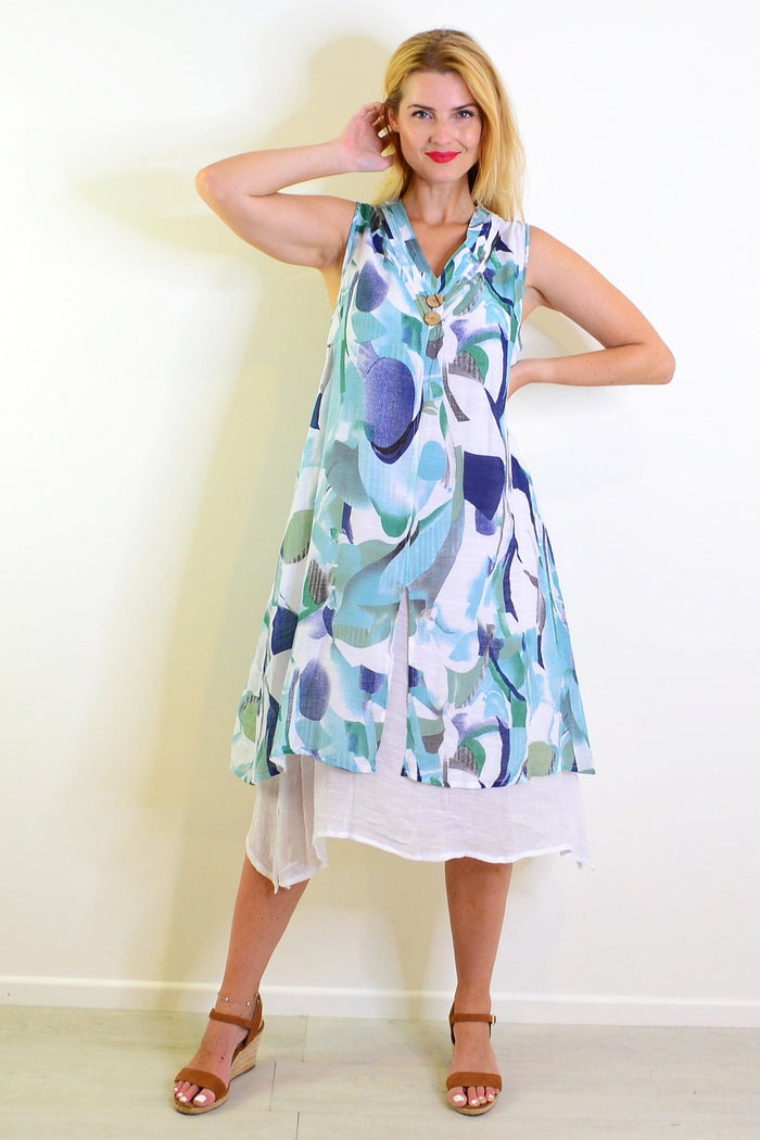 Abstract aqua tones sleeveless tunic dress by Indigo Designs, featuring a flowing fabric and vibrant watercolor-inspired pattern.