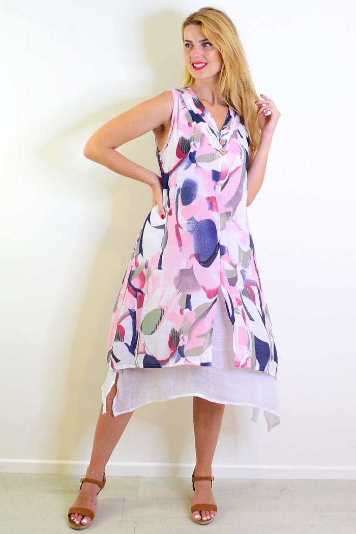 Abstract pink-toned sleeveless tunic dress by Indigo Designs displayed on a hanger.