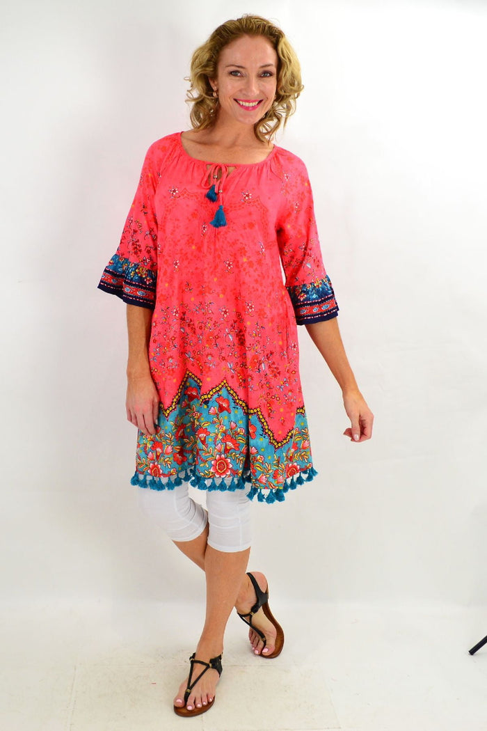Orientique Bagatelle 3/4 sleeve tunic dress with a relaxed fit and floral pattern, displayed on a hanger.