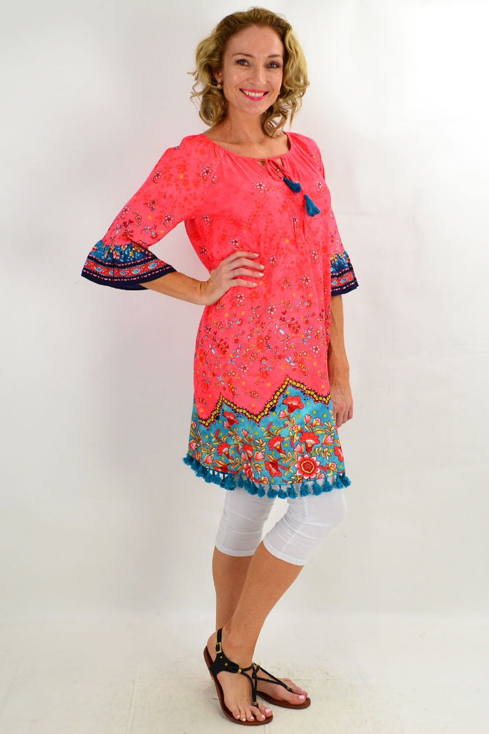 Orientique Bagatelle 3/4 sleeve tunic dress shown on a mannequin with a colorful floral pattern and relaxed fit.
