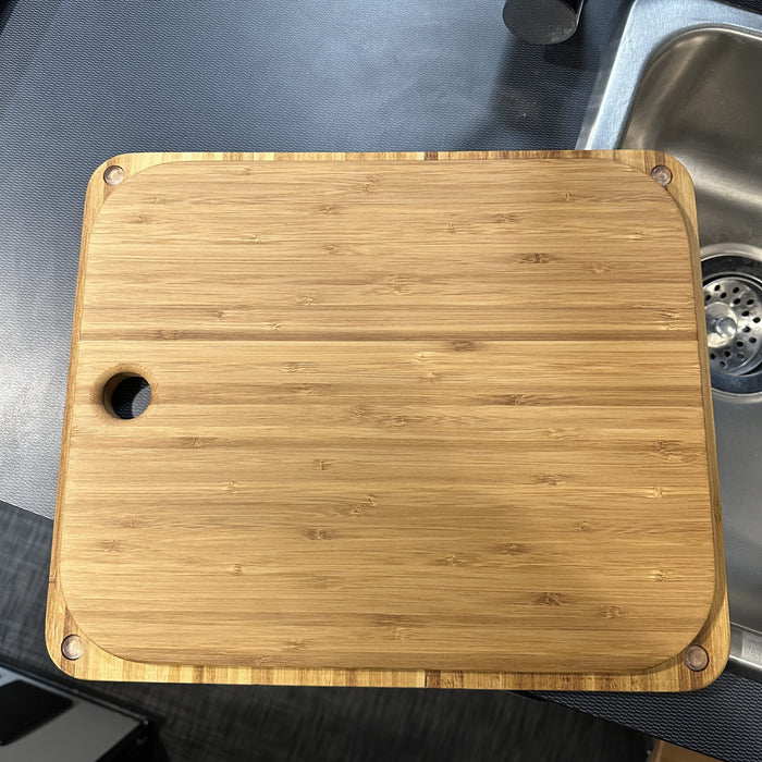 Bamboo sink cover placed over a van kitchen sink, custom fit for Revel, Jayco, Entegra, and Tiffin models.