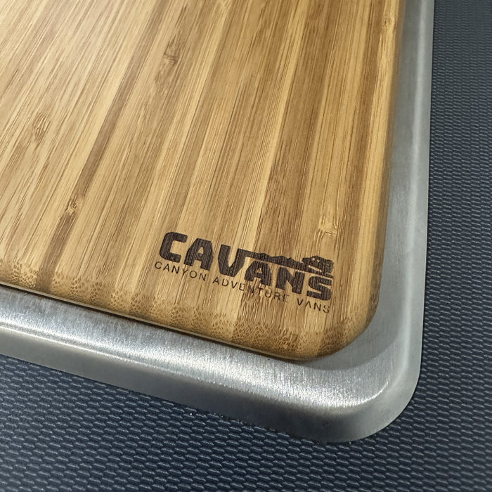 Bamboo sink cover with CAV logo designed for van kitchens, shown on textured countertop.