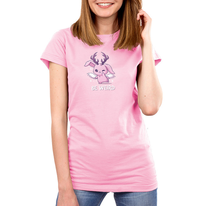 Premium Cotton T-shirt_TeeTurtle light pink Be Weird apparel featuring a winking wolpertinger. Caption says, "be weird".