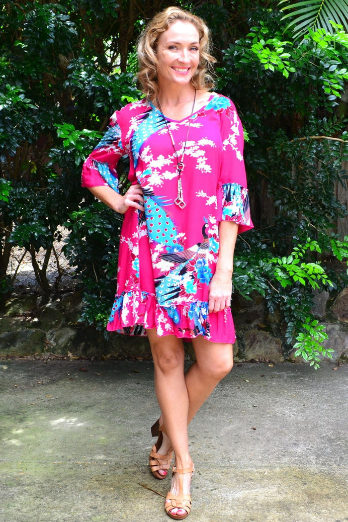Pink peacock print tunic dress with 3/4 sleeves by Freez, showcasing a flowing fabric and vibrant bird pattern.