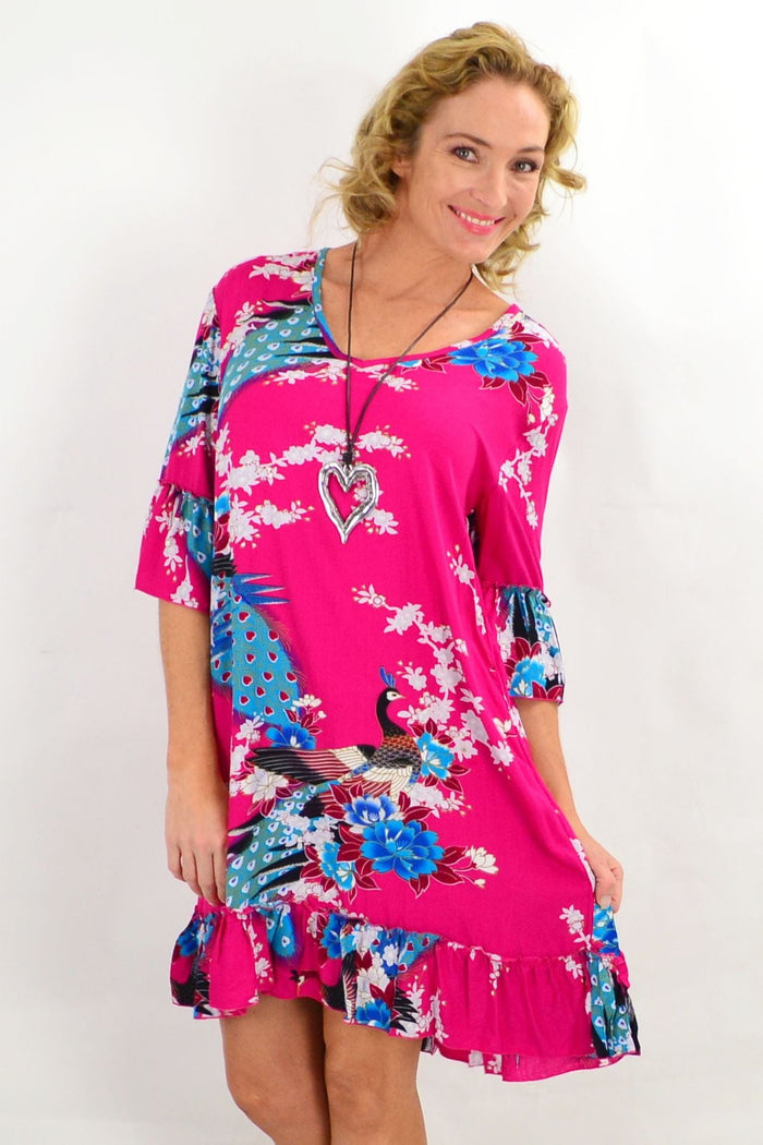 Pink peacock patterned tunic dress with 3/4 sleeves by Freez, showcased on a hanger with a flowing silhouette.