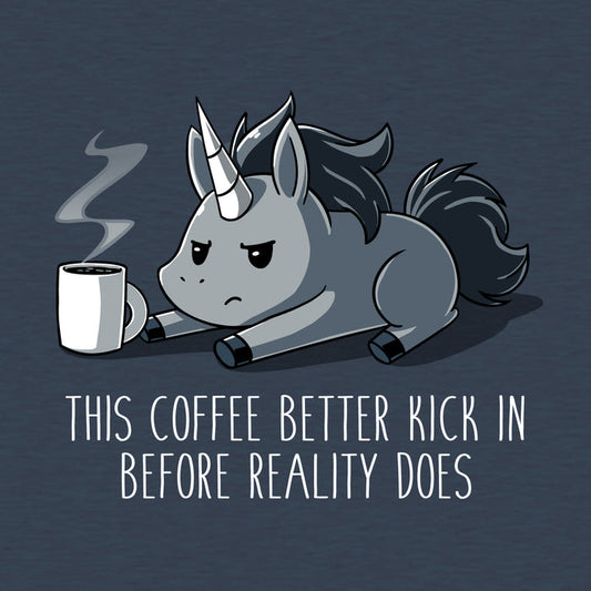 Premium Cotton T-shirt_Teeturtle denim blue Before Reality Kicks In apparel featuring a grumpy-looking unicorn on its stomach with a cup of steaming coffee in front of it. Caption reads 'This coffee better kick in before reality does".