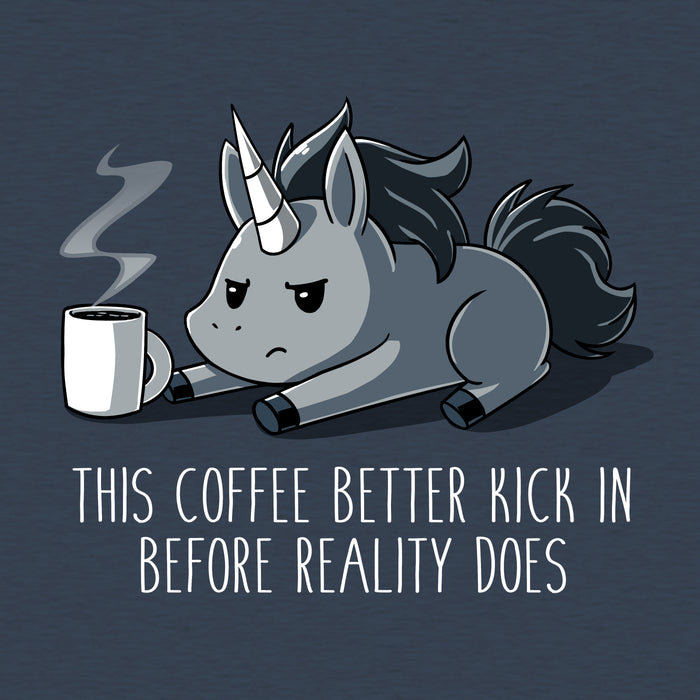 Classic Cotton T-shirt_Teeturtle heather navy Before Reality Kicks In apparel featuring a grumpy-looking unicorn on its stomach with a cup of steaming coffee in front of it. Caption reads 'This coffee better kick in before reality does".