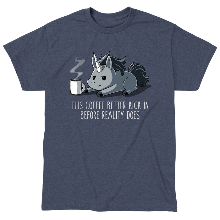 Classic Cotton T-shirt_Teeturtle heather navy Before Reality Kicks In apparel featuring a grumpy-looking unicorn on its stomach with a cup of steaming coffee in front of it. Caption reads 'This coffee better kick in before reality does".