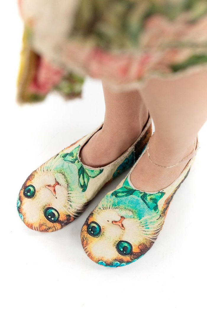 Artisan Magnolia Pearl cat face shoes with whimsical vintage design, worn with floral dress