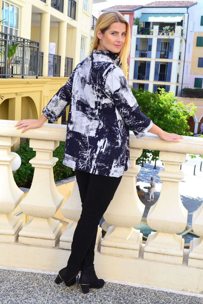 Black and white high collar tunic shirt by Ruby Rain, featuring a stylish collar and relaxed fit, front view with details visible.