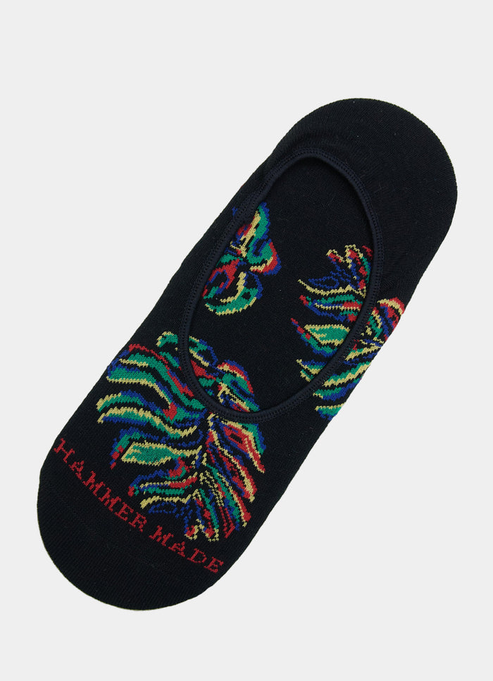 The Black/Multi Monstera No Show Socks are black, feature a vibrant monstera design, "HAMMER MADE" in red near the toe, and have adjustable sizing for a comfortable fit in sizes 8-12.
