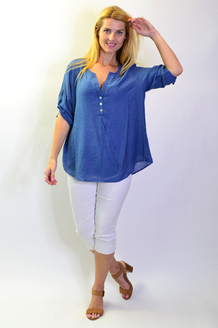 Stylius Blue Lagoon Tunic Top displayed on a hanger, featuring a relaxed fit and vibrant blue color with a lightweight fabric.