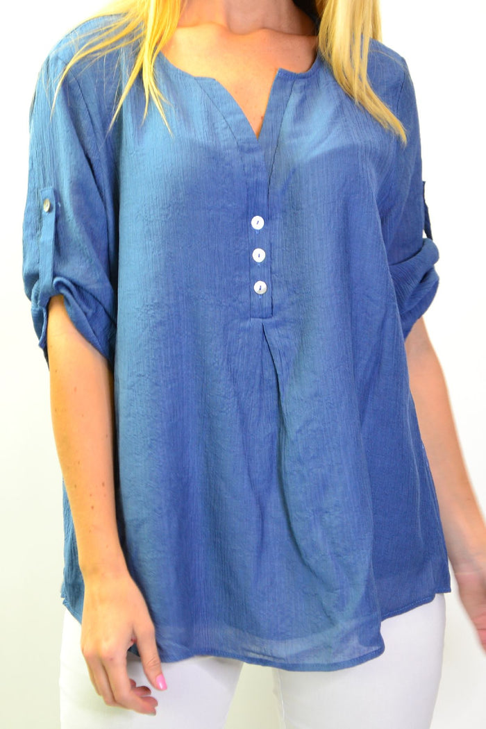 Blue Lagoon Stylius tunic top with long sleeves and relaxed fit, shown on a hanger. Stylish casual wear for women.