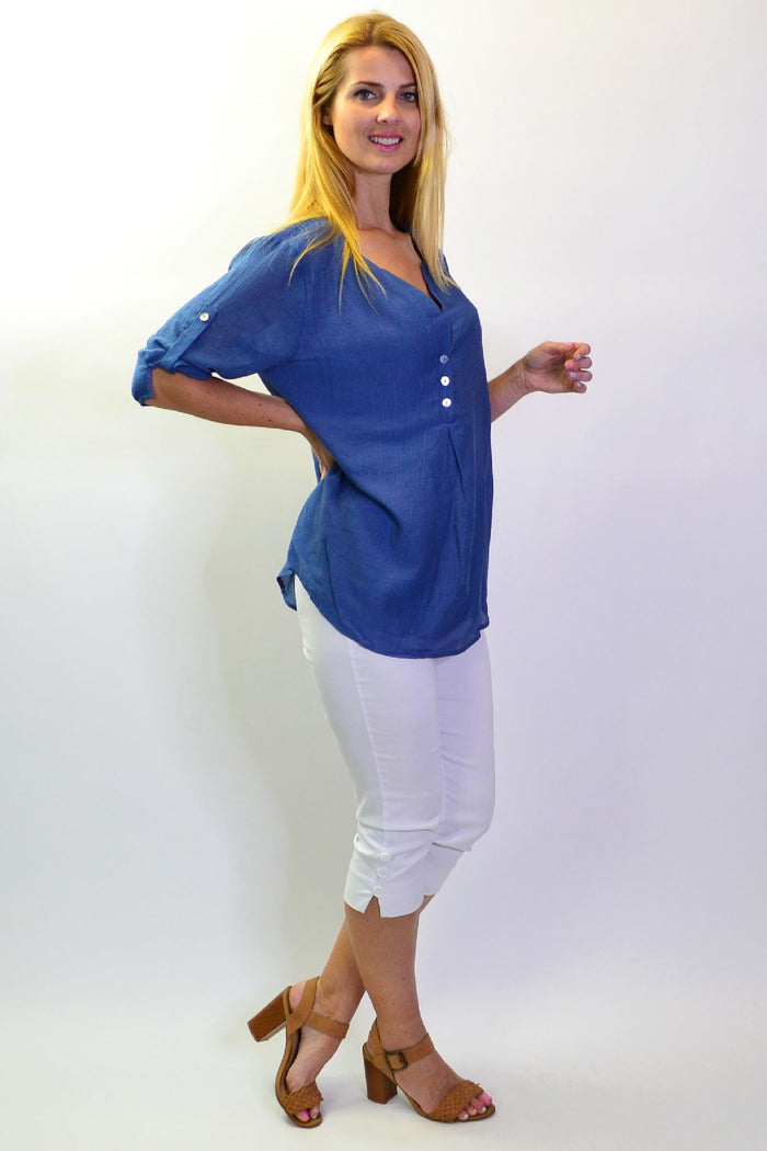 Blue Lagoon Stylius tunic top displayed on a hanger, featuring a relaxed fit and vibrant blue fabric.