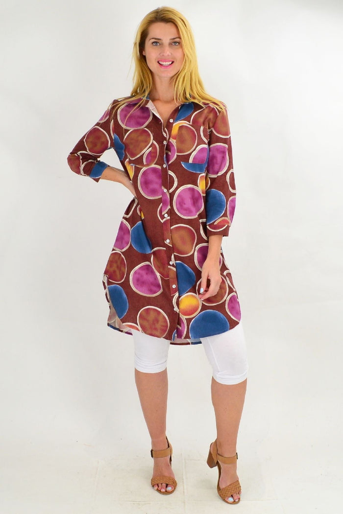 Brown colorful circles patterned tunic shirt by Ruby Rain, displayed on a hanger with a casual fit and vibrant design.