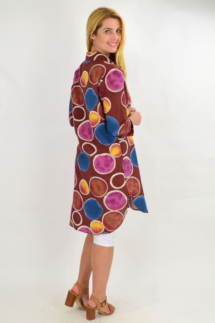 Brown tunic shirt by Ruby Rain featuring colorful circle patterns, long sleeves, and a relaxed fit for casual summer wear.