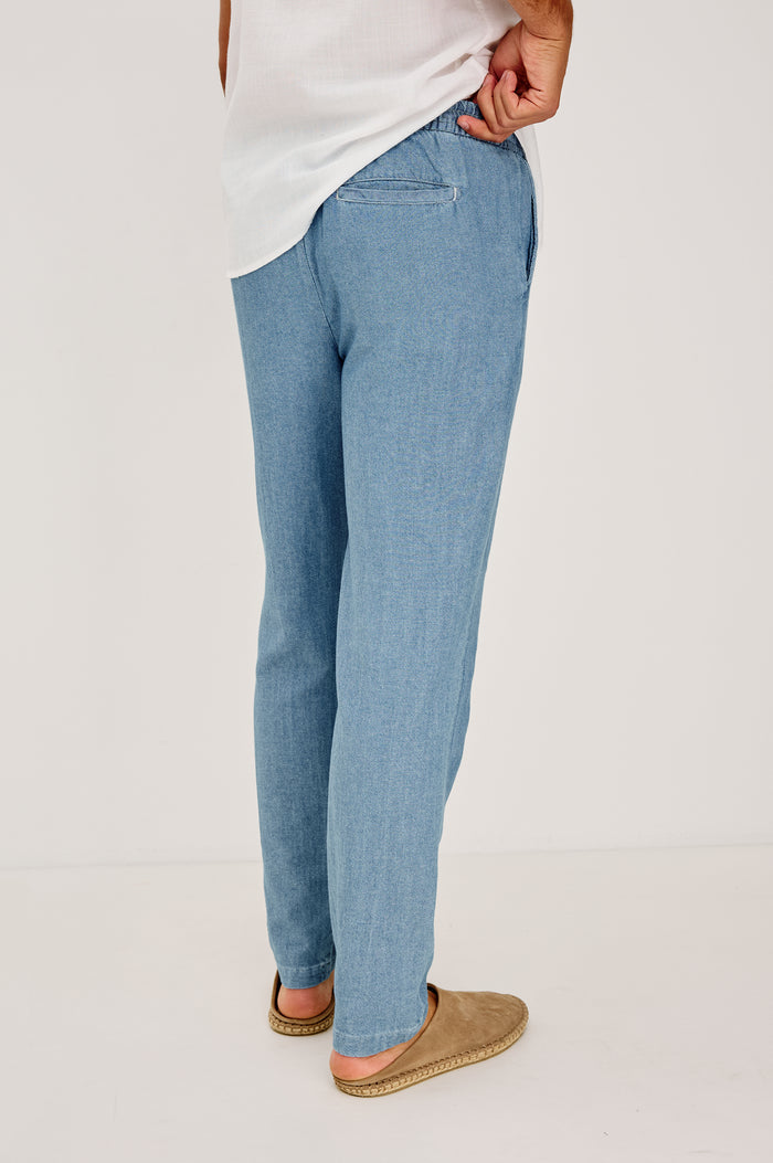 Callum Tapered Straight Leg Pant in Linen Twill With Adjustable Drawstring Waistband Ties in Medium Wash Indigo Colorway - Lower Body Back View Featured on Model
