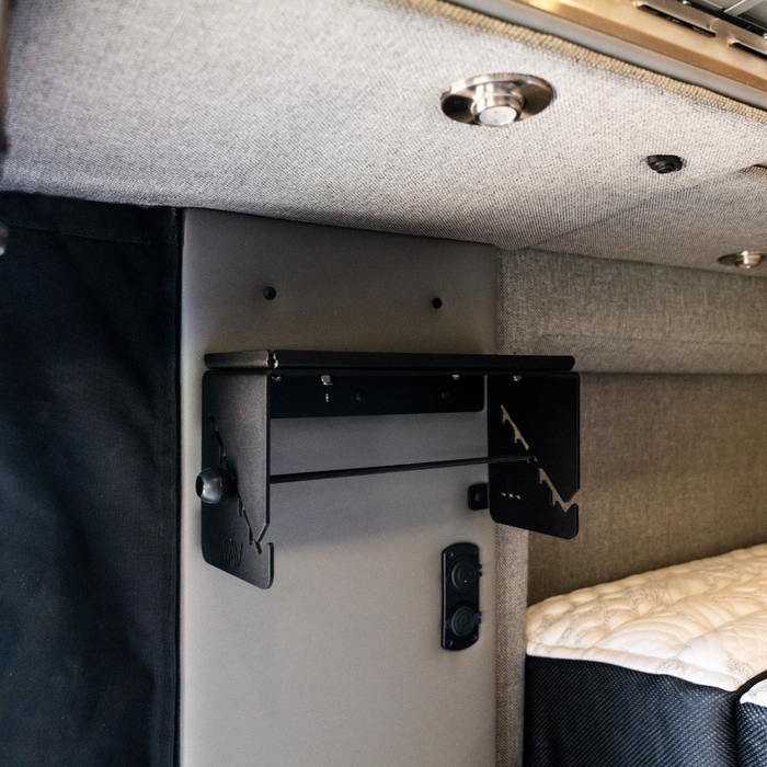 Canyon paper towel holder mounted under van cabinet near bed and control panel
