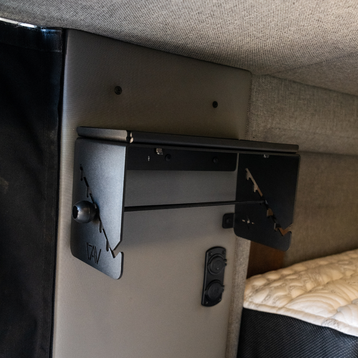 CAV Canyon paper towel holder mounted inside a van near bed and power outlets.