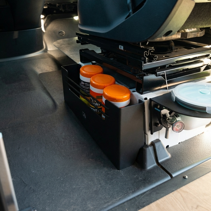 black Canyon Passenger Seat Cubby installed in sprinter van showing bungees and armor all wipes in containers