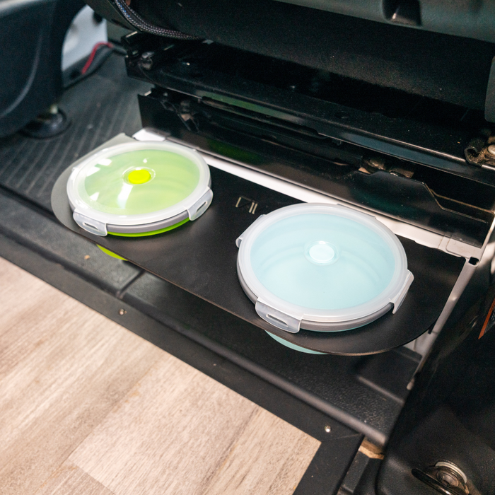 Canyon Pet Bowl set with green and blue lids stored on pull-out tray inside a van.