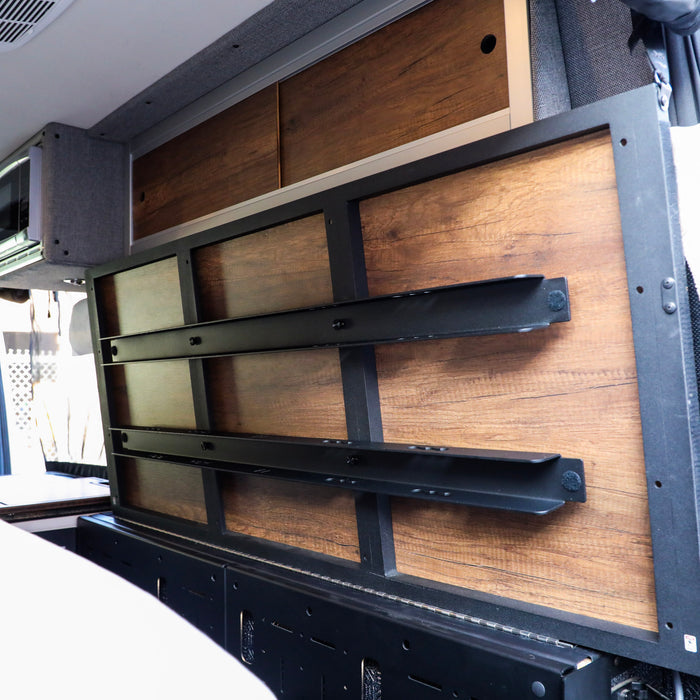 Storyteller Overland Legless Bed Support System 2.0 mounted on van wall with wood paneling
