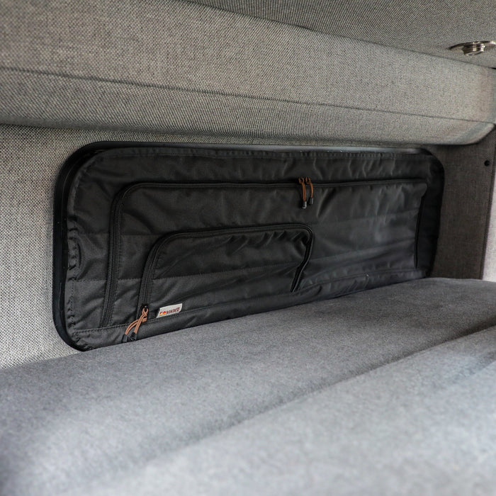 Revel CLIMA-SHADE panel installed over rear window in a van interior with grey upholstery.