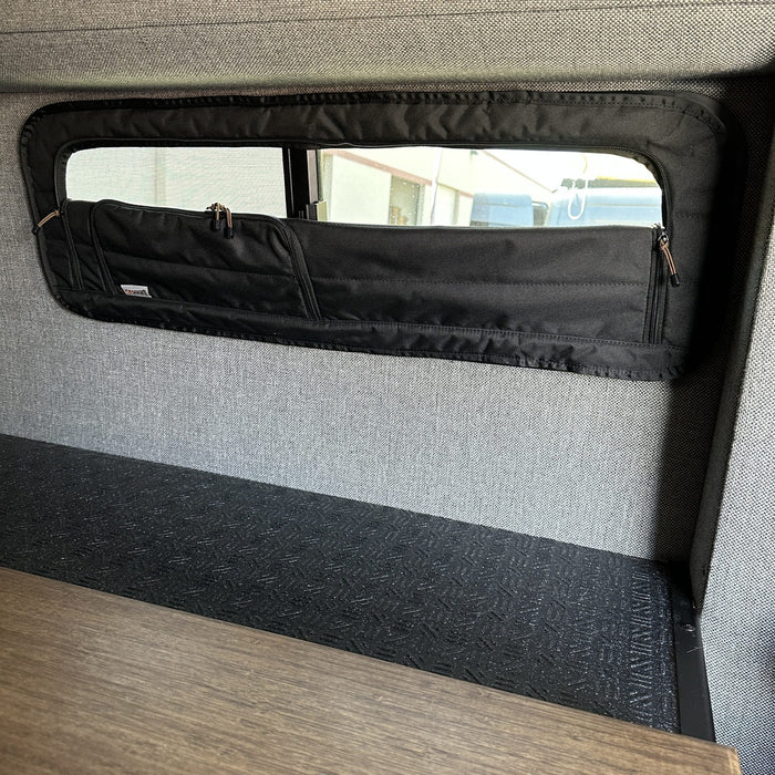 CLIMA-SHADE insulated bunk window cover installed in a van interior with grey fabric walls.