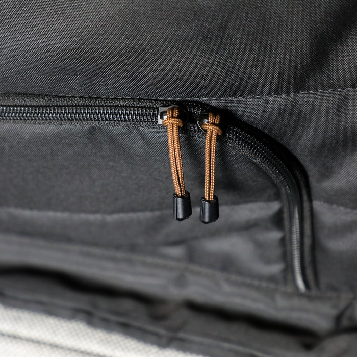 Close-up of black CLIMA-SHADE insulated bunk window cover zipper with dual brown pulls in a van.