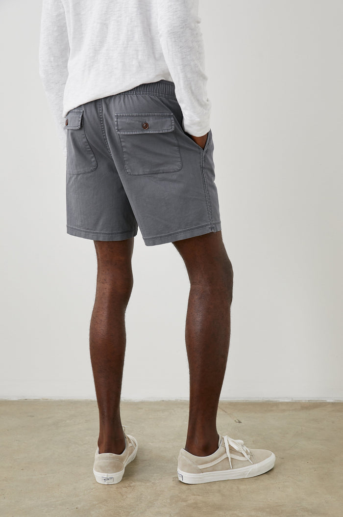 Cruz Shorts with a Drawstring Waist, Two Front Pockets, Two Back Button Flap Pockets in Charcoal Colorway - Back View Featured on Model