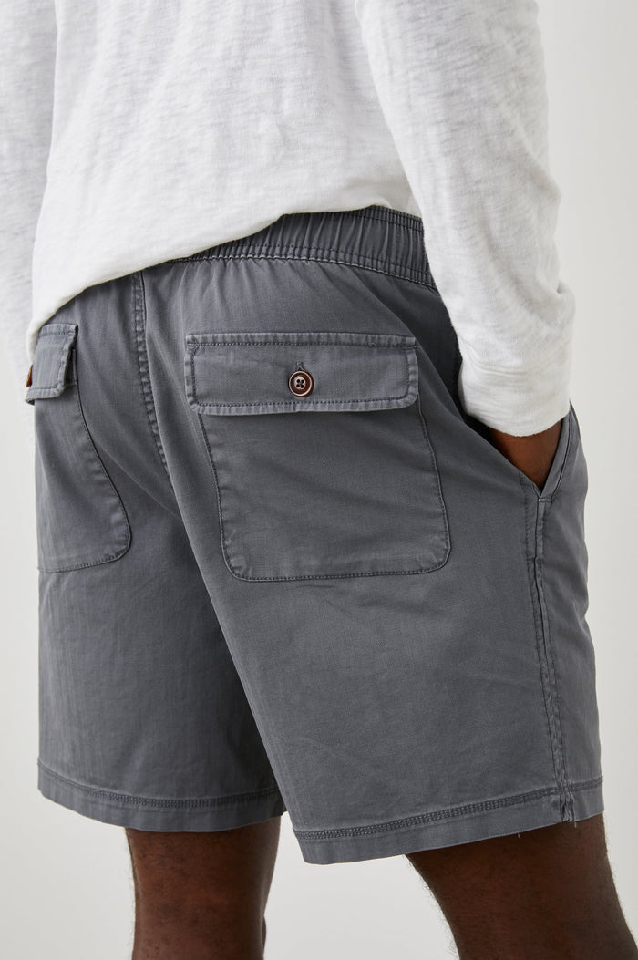 Cruz Shorts with a Drawstring Waist, Two Front Pockets, Two Back Button Flap Pockets in Charcoal Colorway - Back View Featured on Model