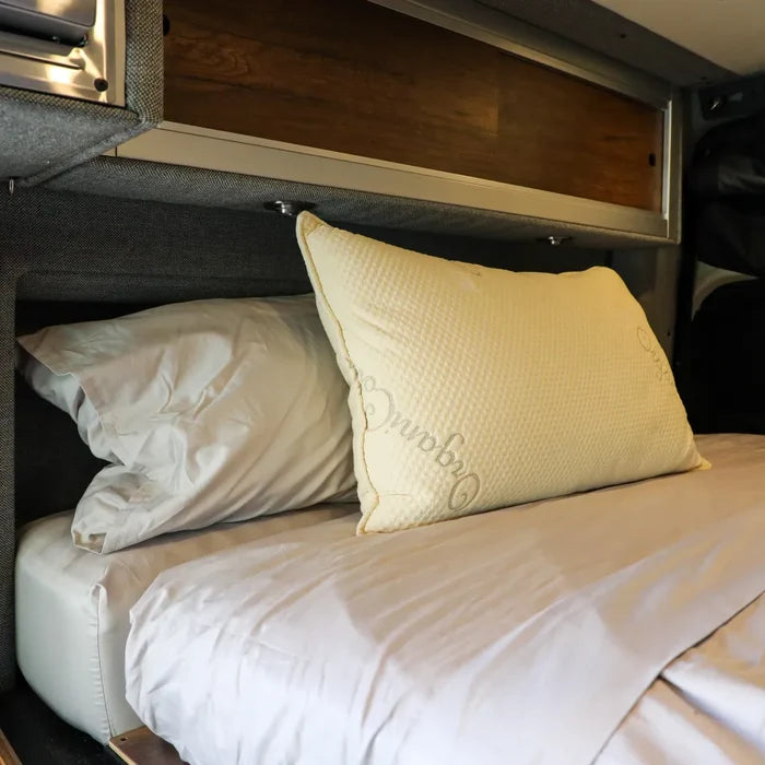 Dream Collection adjustable pillow on a neatly made bed inside a van sleeping area