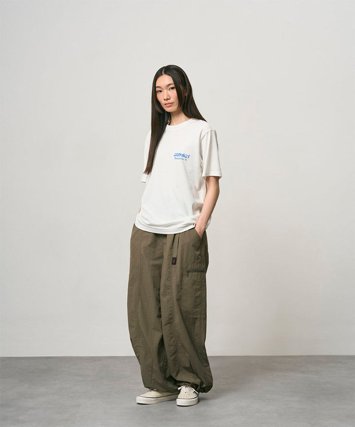Back view of a Gramicci ash heather Earth Tee with a graphic against a light-tone background.
