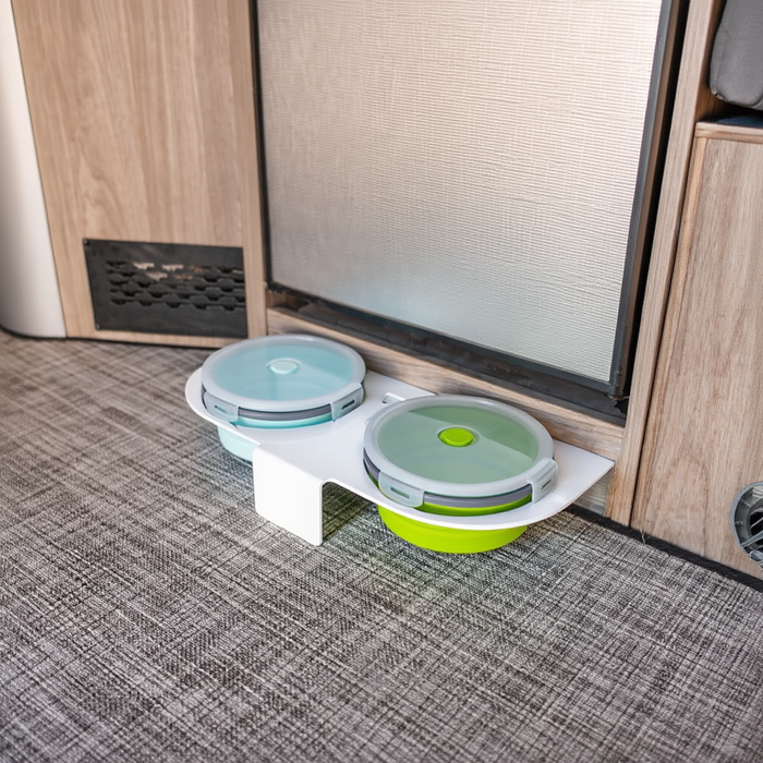Ekko Pet Bowl with dual containers set on a van floor near a cabinet and door