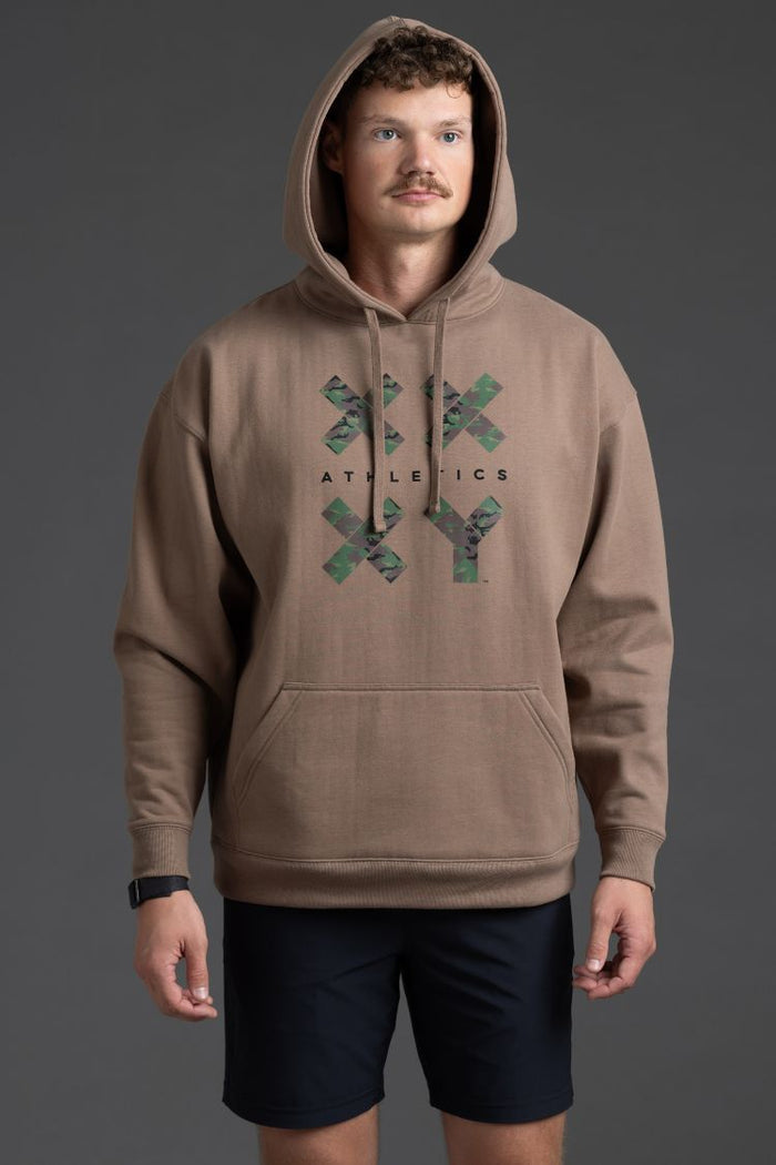 Man wearing a brown hoodie with a logo and text on a gray background || Mocha