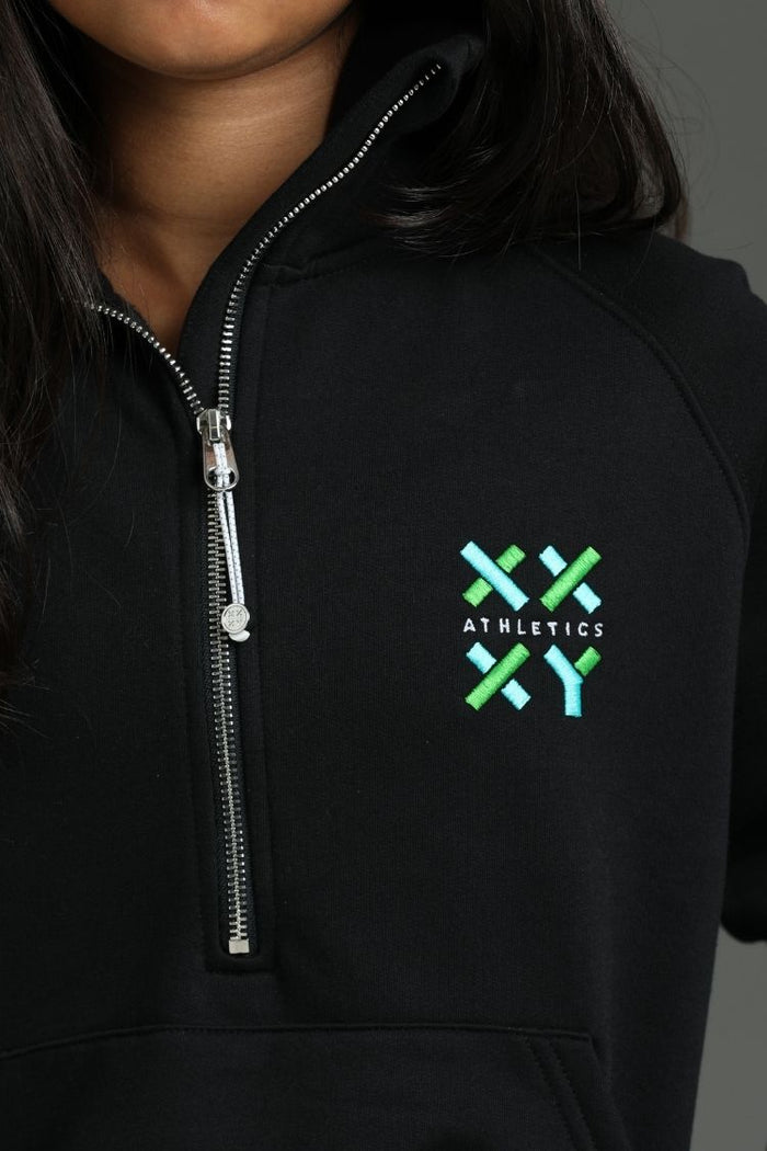 Black hoodie with a green and white logo on the chest against a dark background || Black