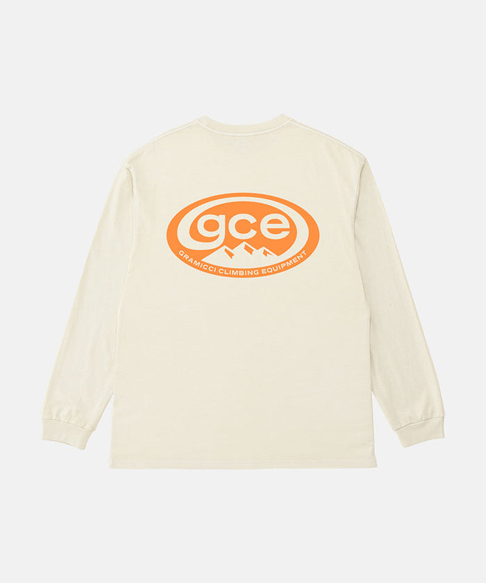 Back view of a Gramicci natural pigment colored GCE Long Sleeve Tee Pigment Dyed with a graphic against a light-tone background.