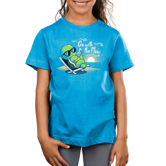 Premium Cotton T-shirt_Teeturtle cobalt blue Go with the Flow apparel featuring a turtle lounging on a beach chair with a tropical drink and sunglasses as the sun sets in the distance with the words 'Go with the Flow' to one side.