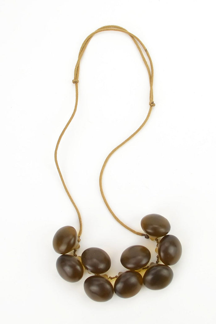 Grape necklace by I Love Tunics featuring a string of grape-shaped beads on a silver chain.