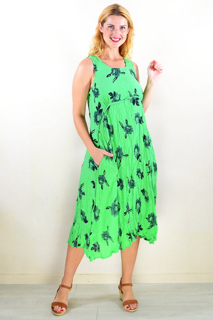 Green sleeveless tunic dress by Willow Tree, flowing fabric, and simple sleeveless design displayed on a mannequin.
