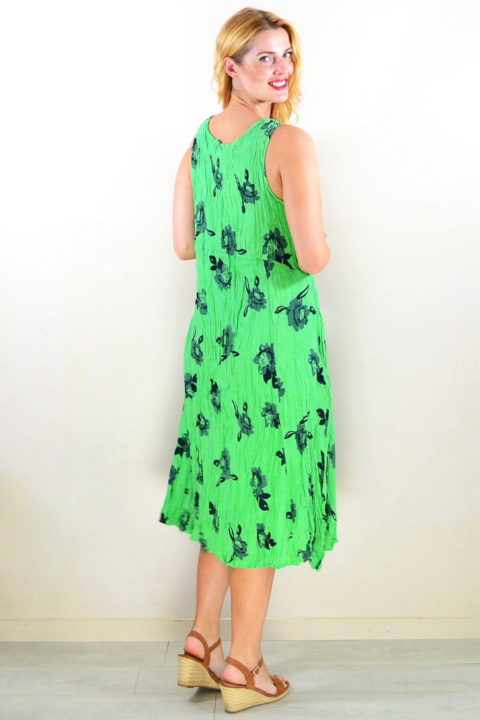 Green sleeveless tunic dress by Willow Tree, lightweight fabric with a relaxed fit and simple round neckline, shown on a hanger.