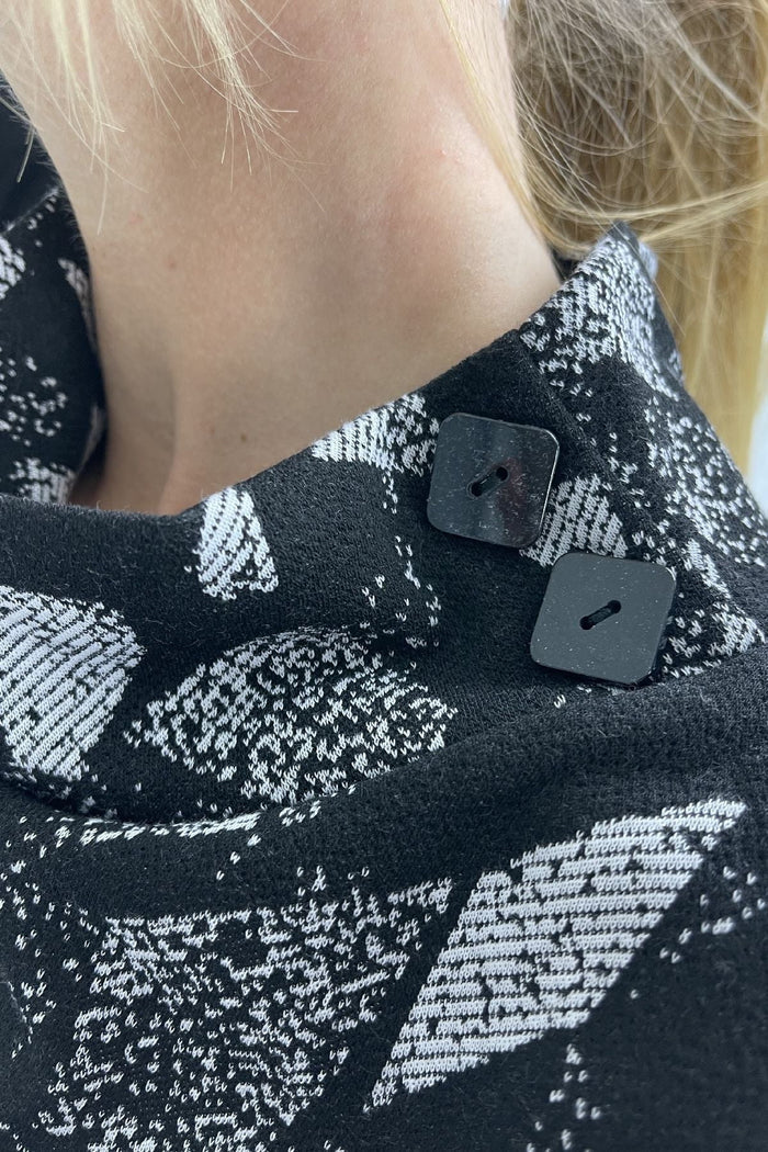 Grey smart abstract tunic top by Whispers, featuring a modern design and relaxed fit, displayed on a hanger.