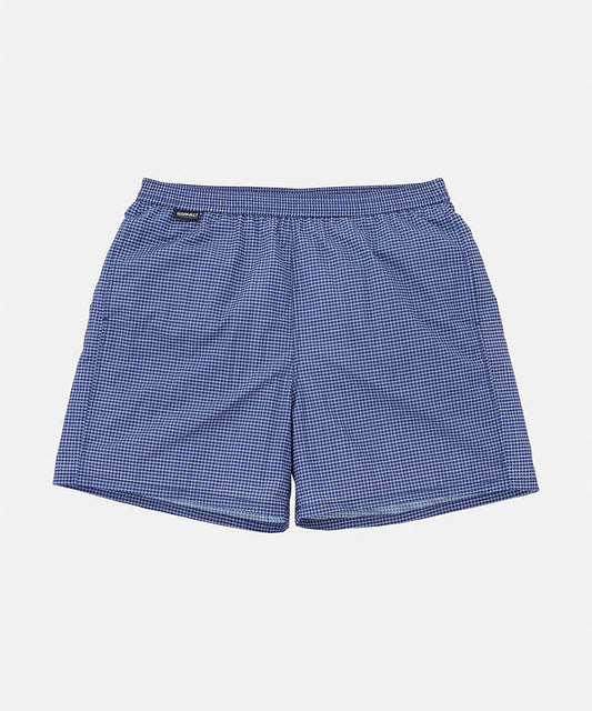 Front view of navy checkered Gramicci Grid Swim Shorts against a light-tone background.