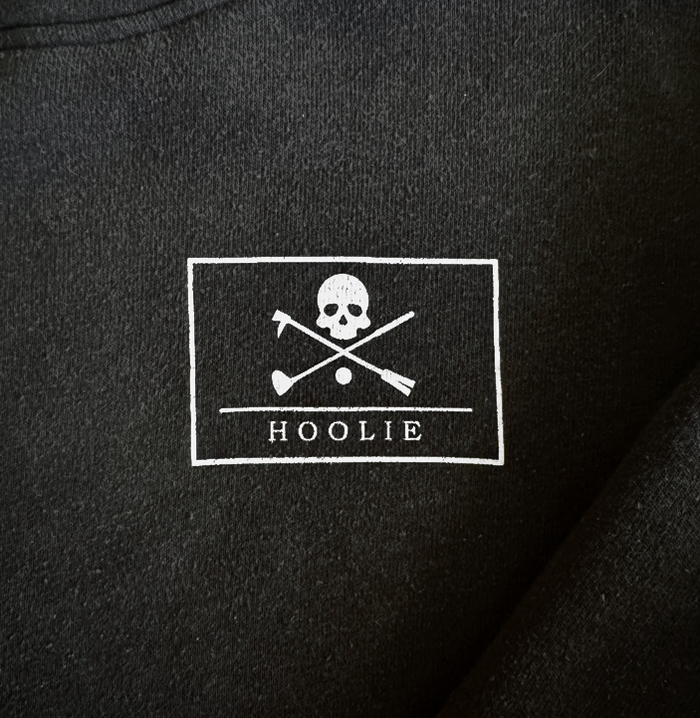 Men’s Golf Hoodie in black featuring Hoolie Roger skull-and-crossbones design.