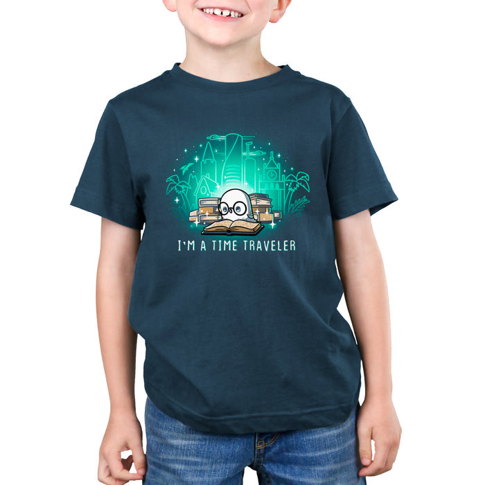 Premium Cotton T-shirt_Teeturtle denim blue I'm a Time Traveler apparel featuring a cute, glasses-wearing owl reading a book with a stack of books behind them with images of all the different time periods rising from those books and 'I'm a Time Traveler' written below.