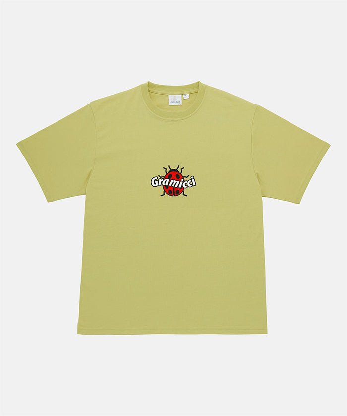 Gramicci sweet pea colored Ladybug Tee with colorful graphic against a light-tone background.