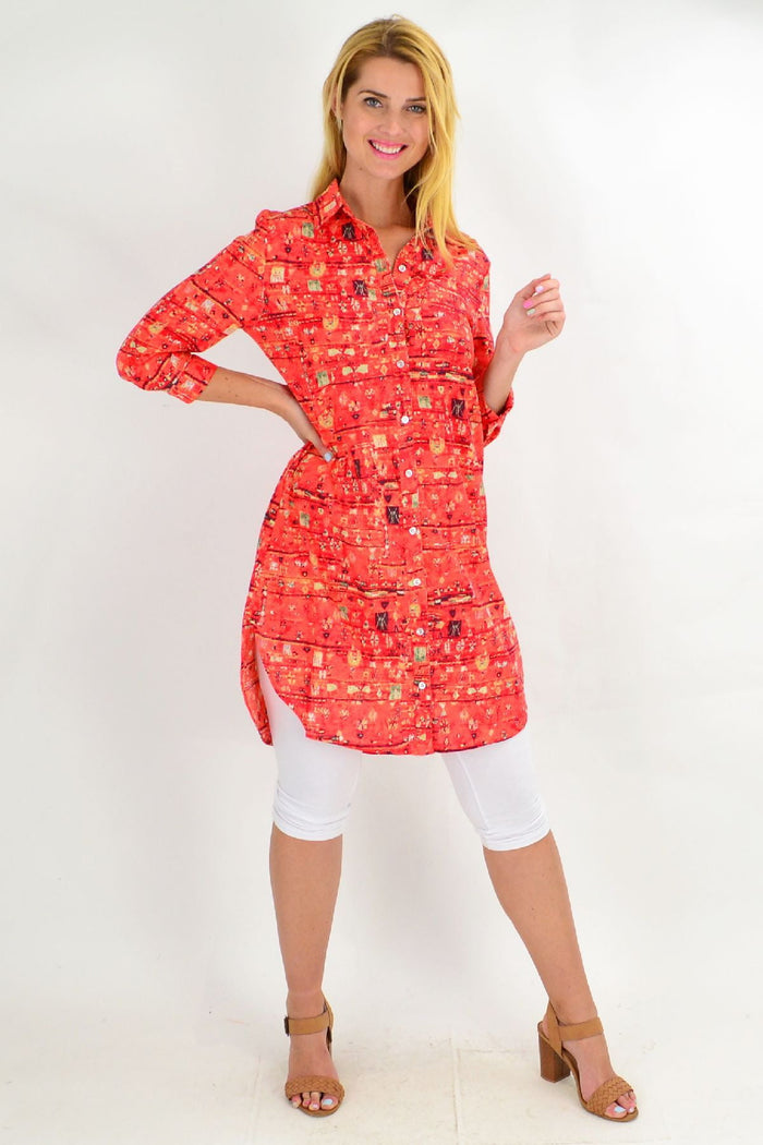 Long orange abstract tunic shirt by Ruby Rain, featuring a flowing design and vibrant pattern, perfect for casual or boho styles.